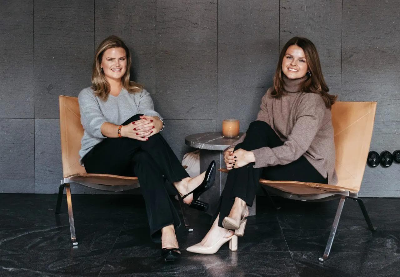 Founders Emma and Sara seated together